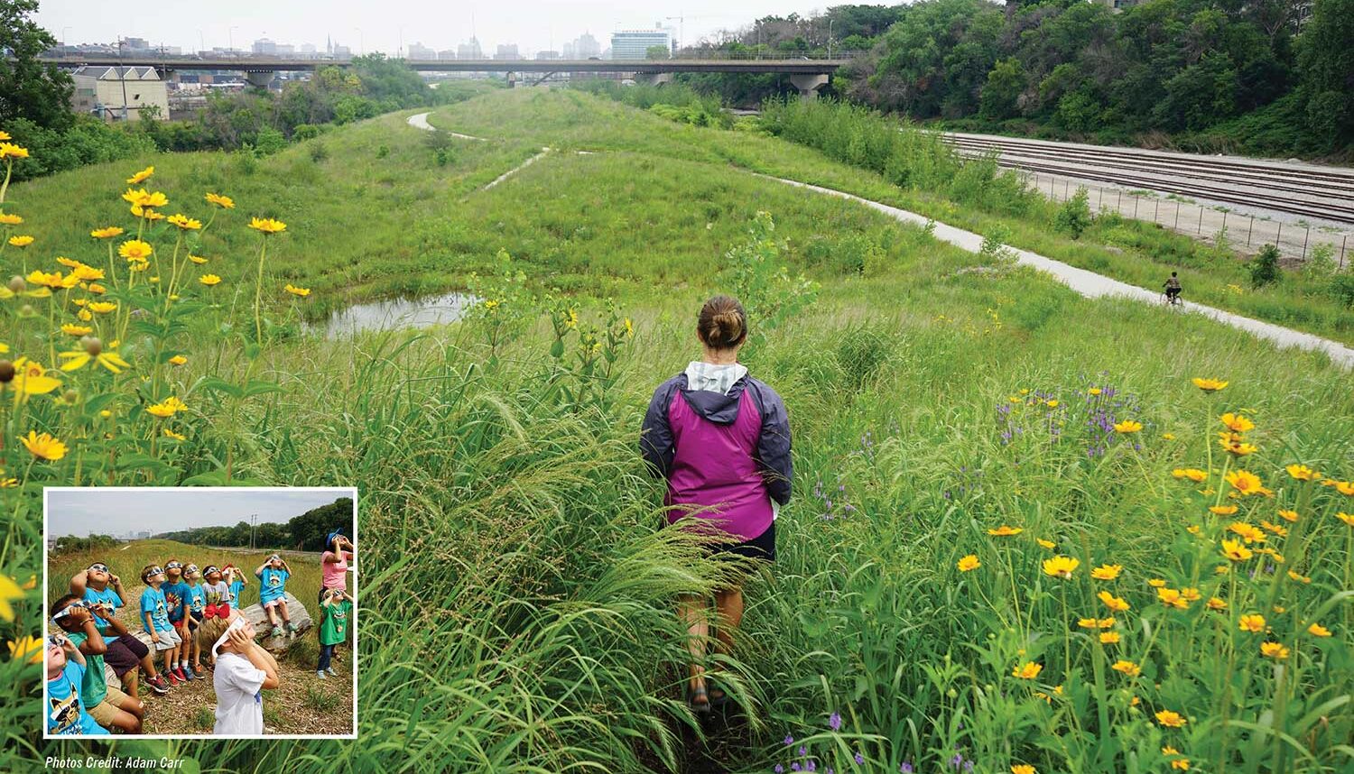 Two images. The large image shows a woman walking a discrete dirt path through tall meadow grasses and flowers towards a low-lying pond. The smaller image is of kids sitting on a log with glasses equipped for the eclipse looking up at the sky.