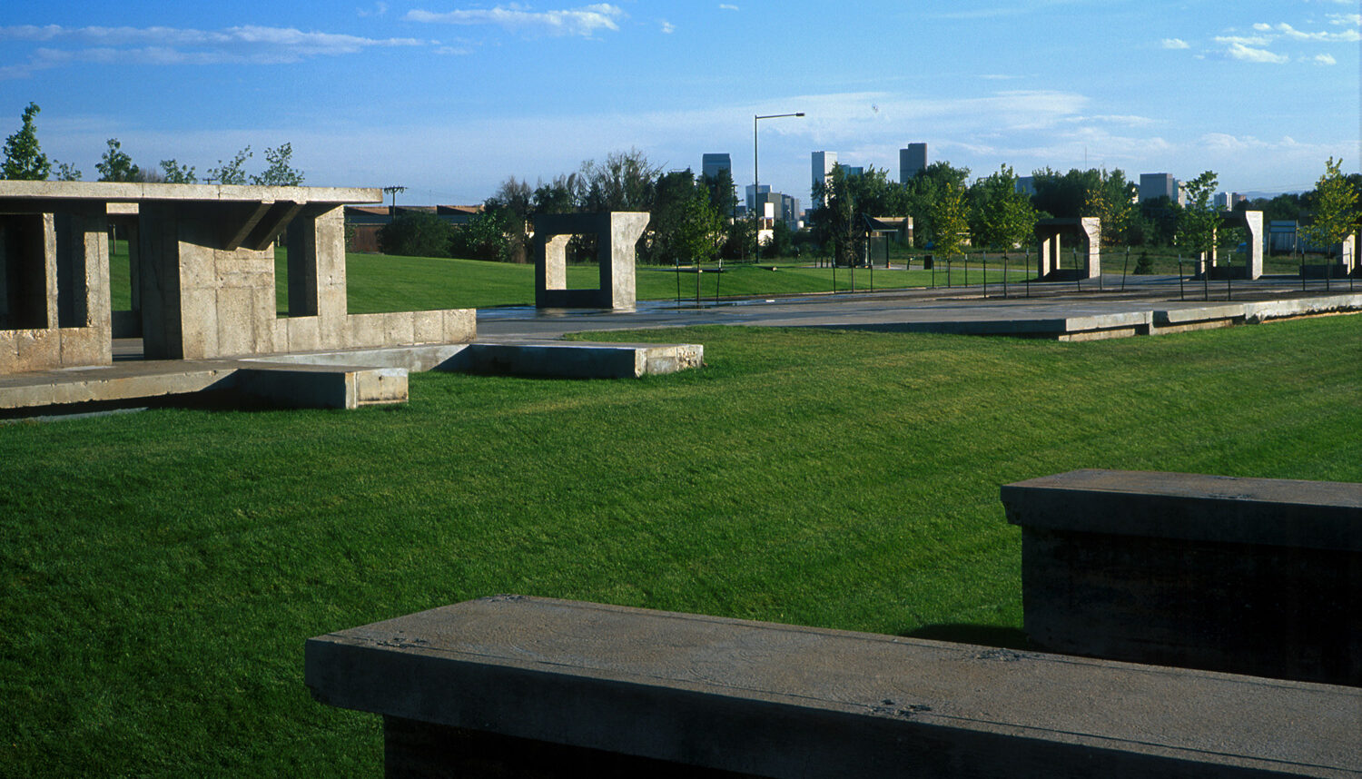 The photo shows leftover concrete forms embedded in turf grass.