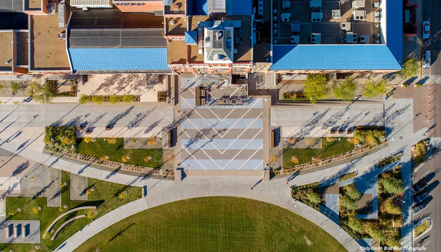 A drone image directly above the Tivoli building entrance shows decorative plaza and the turf lawn.