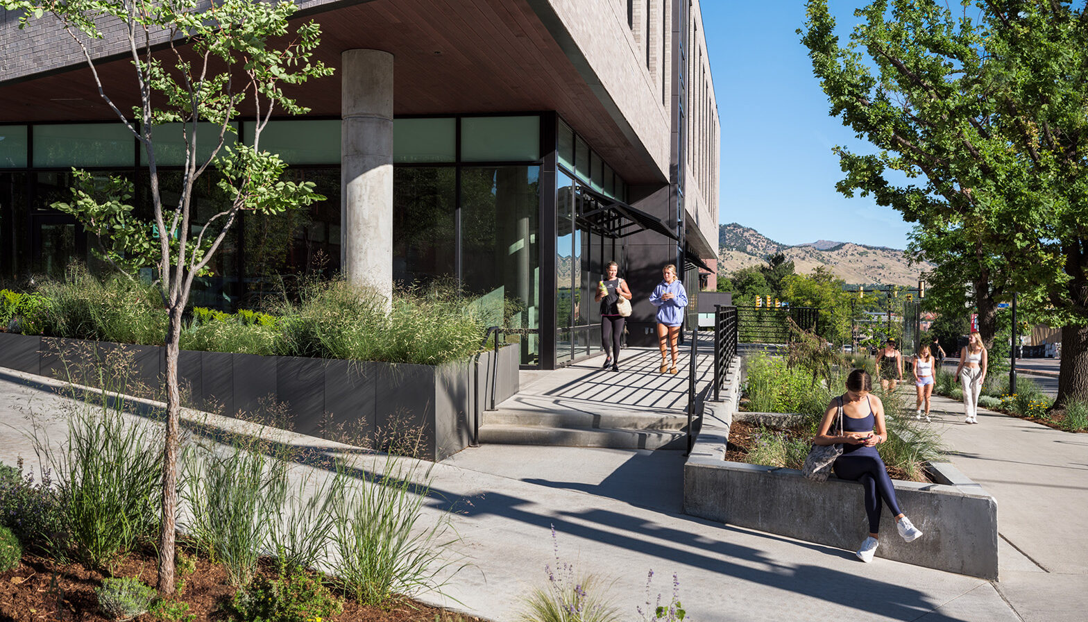 Street edge with plantings and seat walls for passerbys to stop and take a phone call.