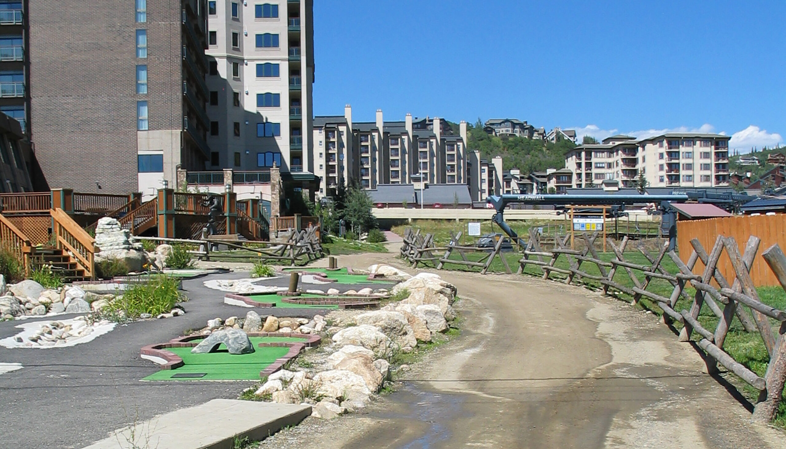 before image of the Steamboat Base area shows an empty miniature golf course, a poorly drained dirt road, and log fencing