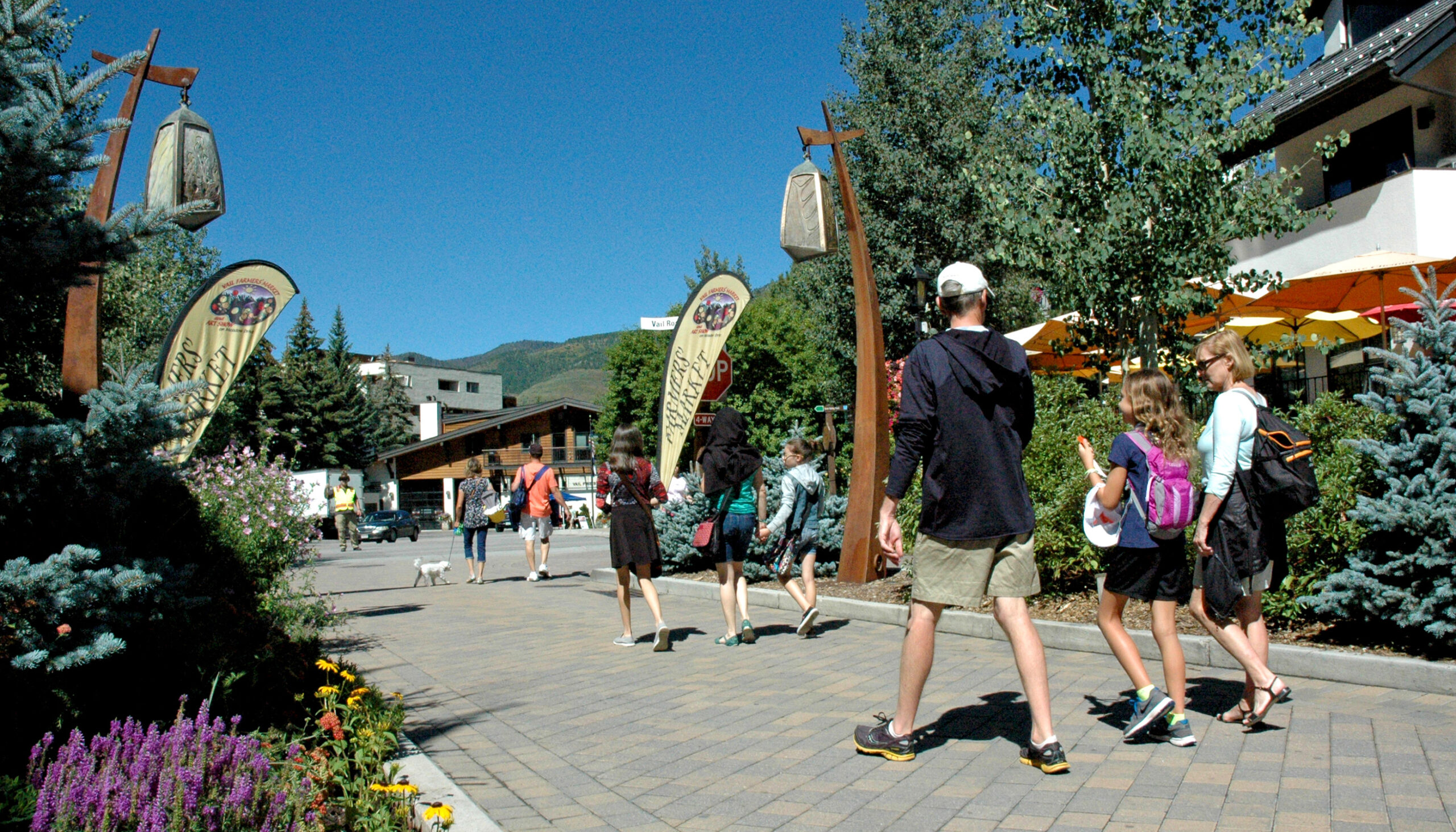 Pedestrian street near a bus stop in Vail Village with unique entry lamp posts